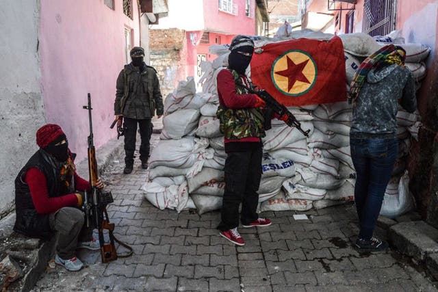 Armed PKK members man a barricade in the Sur district of Diyarbakir