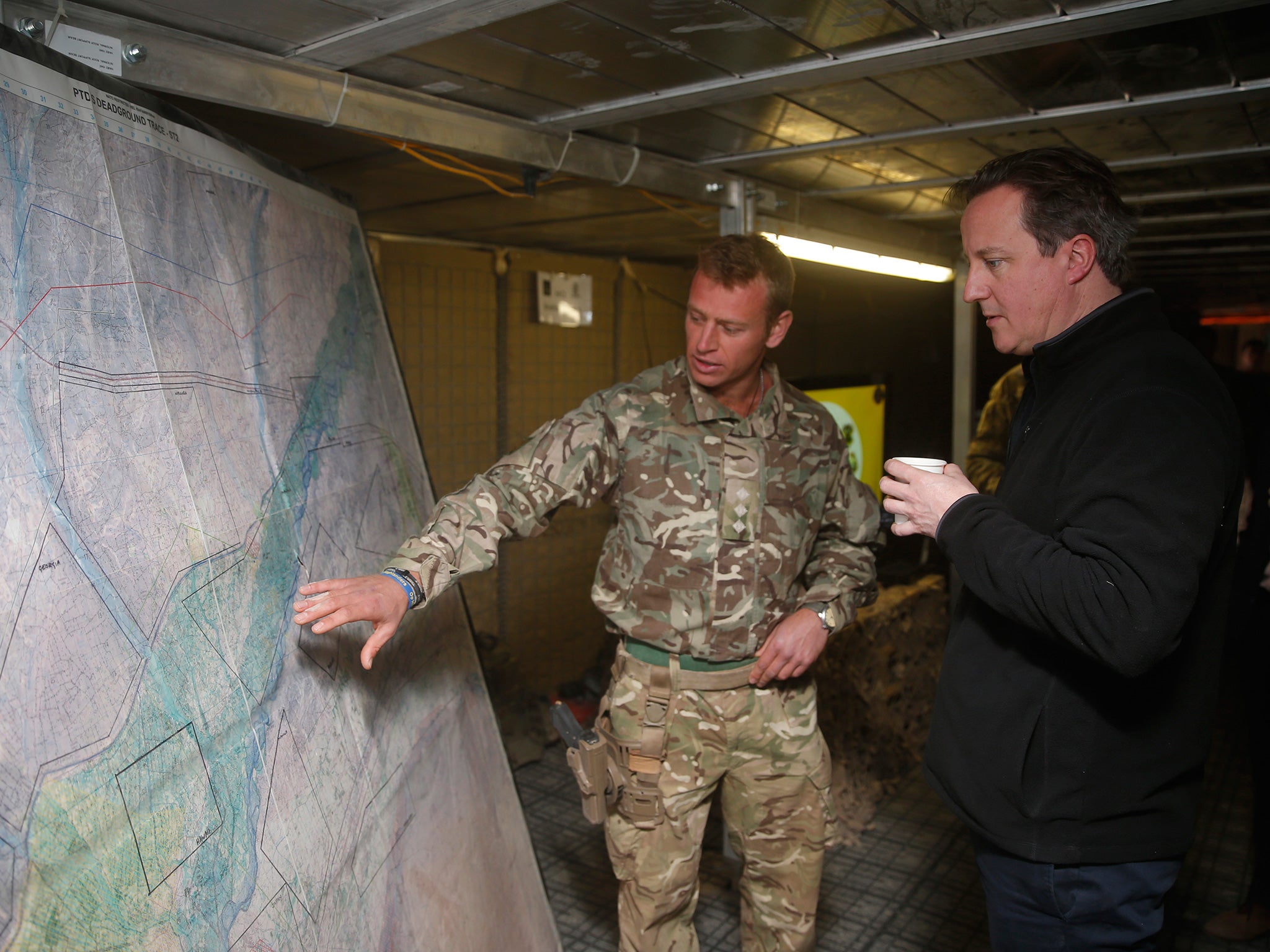 David Cameron listens to a briefing by a British army officer in Helmand Province