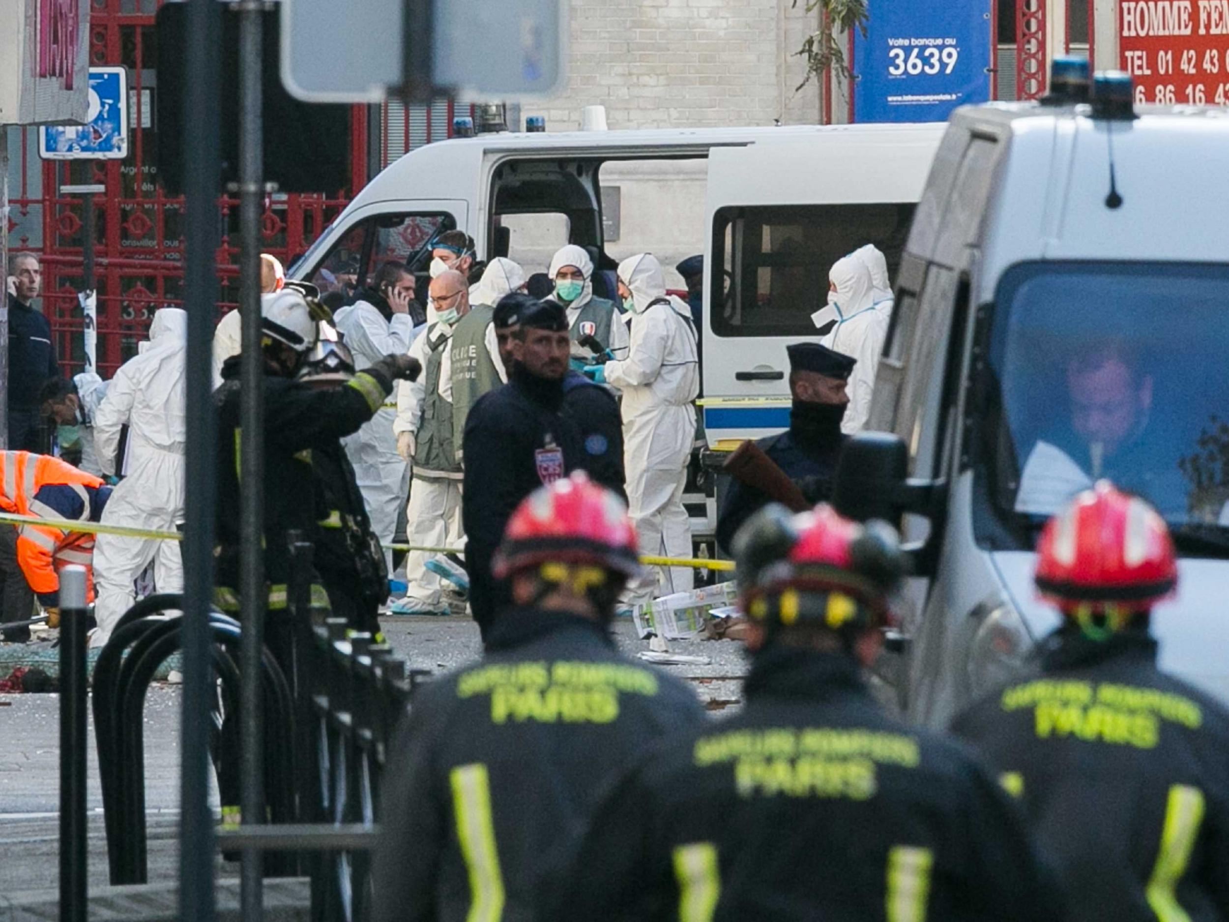 Forensics teams from the French police are seen on 'Rue du Corbillon' in Saint-Denis