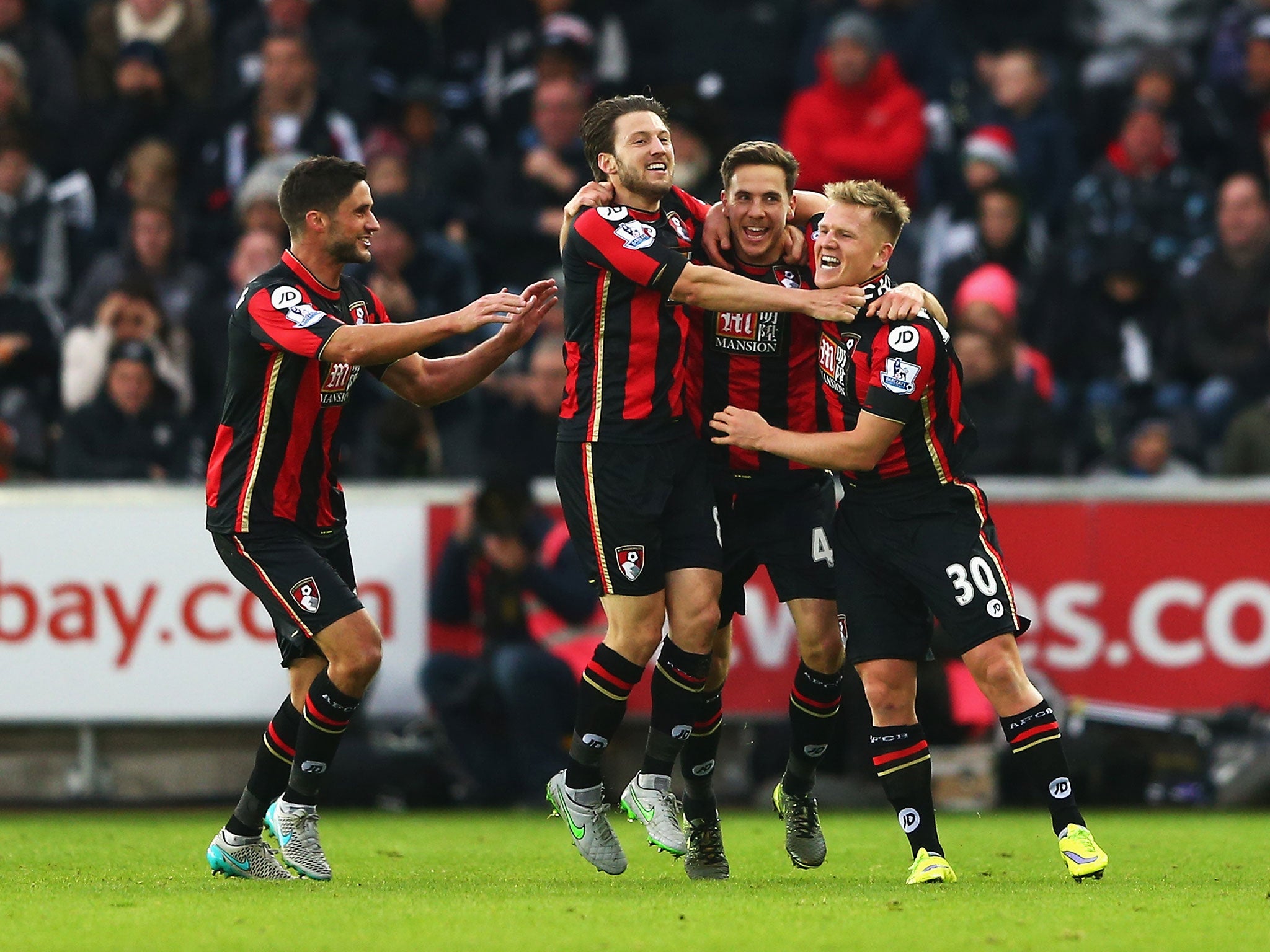 Bournemouth players celebrate after Dan Gosling scores their second against Swansea