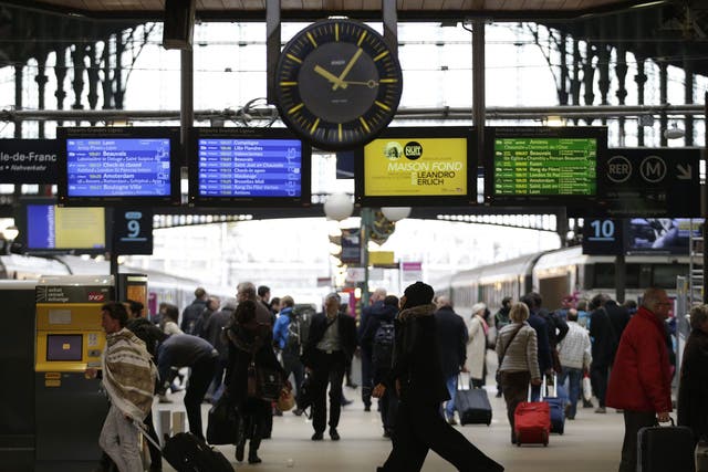 Commuters and travellers walks through the Gare du Nord railway station on November 16, 2015 in Paris, three days after the terrorist attacks that left 130 dead and more than 350 injured
