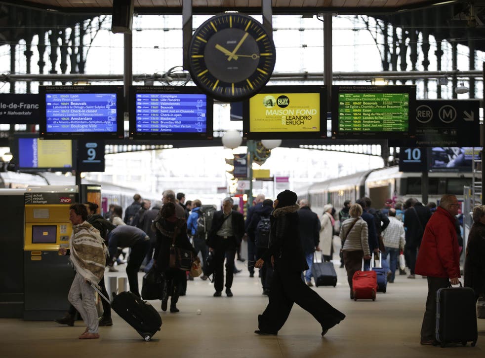 Commuters and travellers walks through the Gare du Nord railway station on November 16, 2015 in Paris, three days after the terrorist attacks that left 130 dead and more than 350 injured