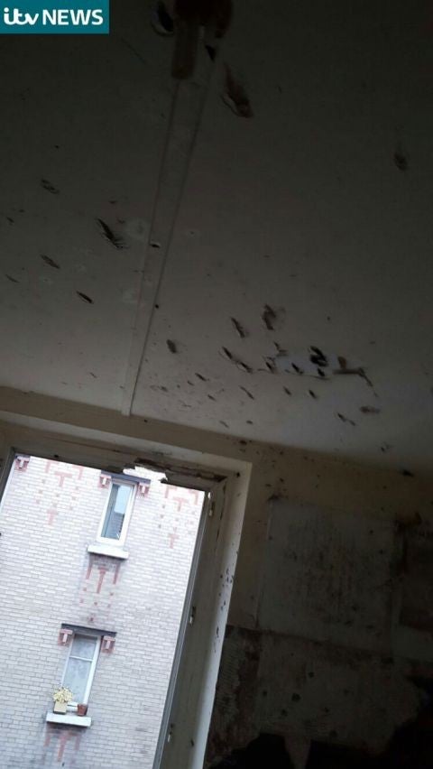 Bullet holes can be seen in the ceiling of the apartment