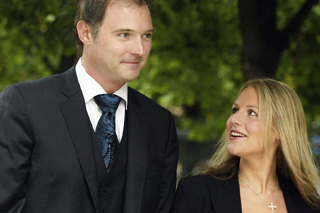 Former television presenter John Leslie (R) speaks to the media after leaving Southwark Crown Court watched by girlfriend Abby Titmuss and two british police officers July 31, 2003 in London, England.