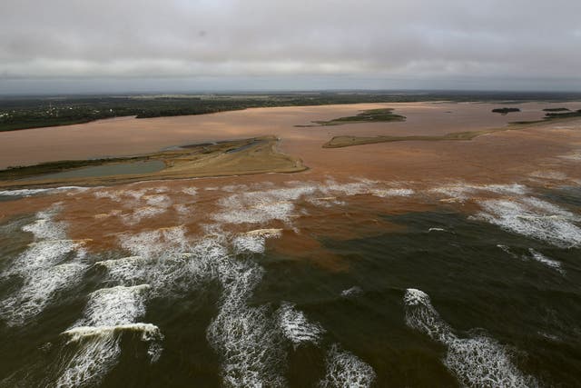 The mouth of the Doce River, flooded with mud after a dam owned by mining firms burst; the disaster has displaced hundreds of people and may affect fish, sea turtles and a coral reef