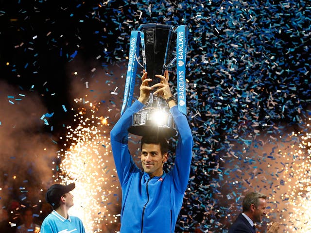 Novak Djokovic celebrates with his World Tour Finals trophy