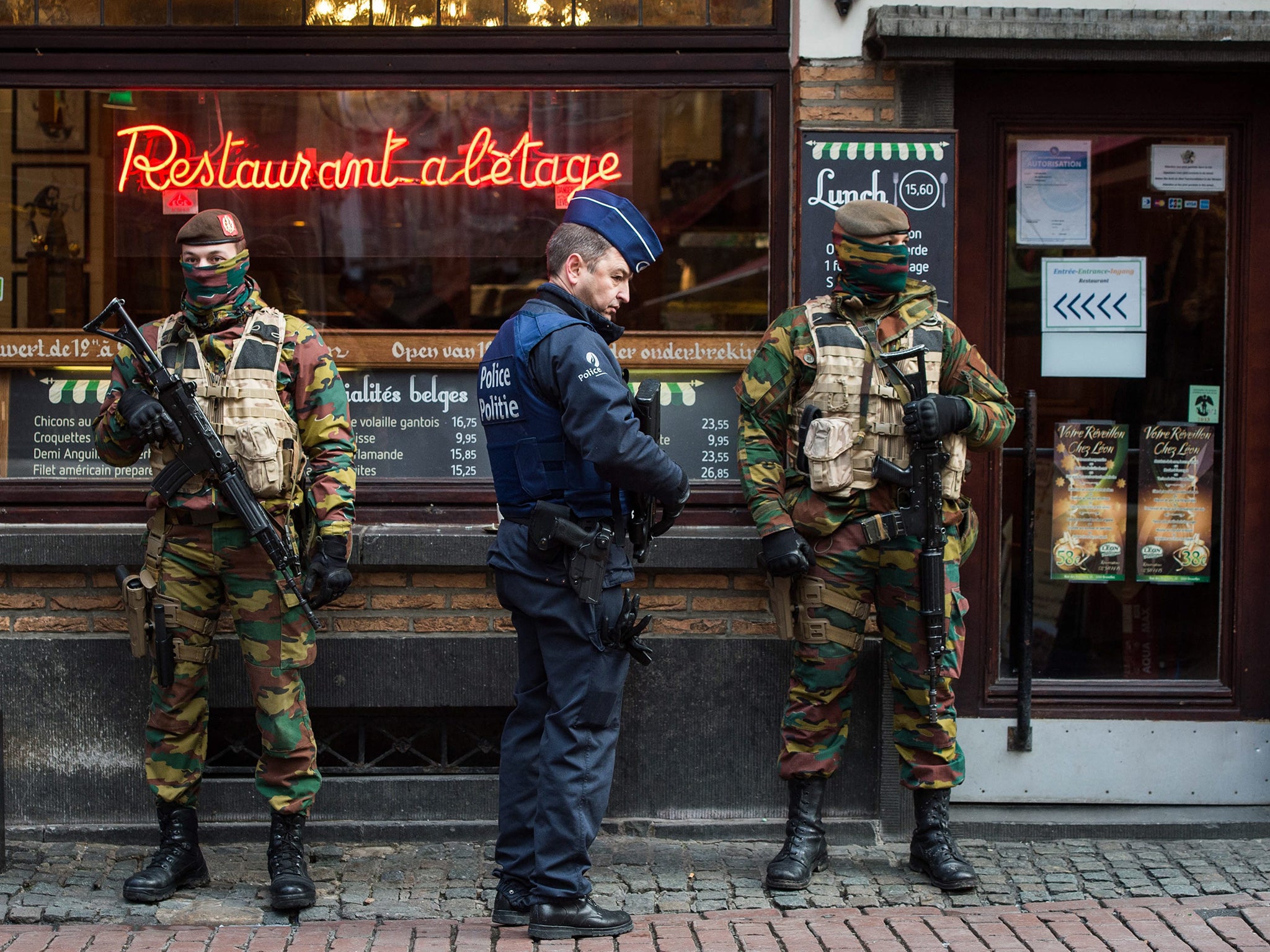 A police officer and soldiers stand guard in the 'Rue des Bouchers' street, famous for it's restaurants, following the terror alert level being elevated to 4/4, in Brussels, Belgium. Belgium raised the alert status at Level 4/4 as 'serious and imminent' threat of an attack, the main effect are closing of all Metro Line in Brussels, all soccer match of league one and two cancelled countrywide. The Belgian government said it had concrete evidence of a planned terrorist attack that would have employed weapons and explosives