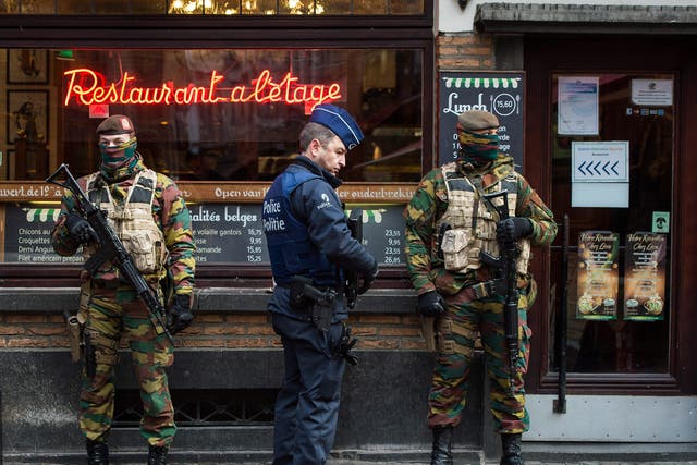 A police officer and soldiers stand guard  in the 'Rue des Bouchers' street, famous for it's restaurants, following the terror alert level being elevated to 4/4, in Brussels, Belgium. Belgium raised the alert status at Level 4/4 as 'serious and imminent' threat of an attack, the main effect are closing of all Metro Line in Brussels, all soccer match of league one and two cancelled countrywide. The Belgian government said it had concrete evidence of a planned terrorist attack that would have employed weapons and explosives