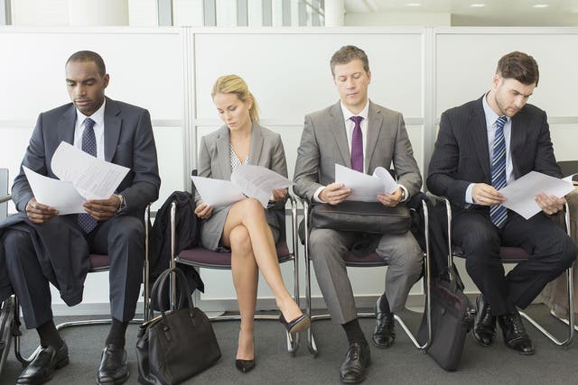 Candidates line up for a job interview