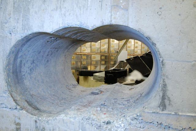 A police shot of the hole drilled into the vault at Hatton Garden Safe Deposit during the Easter raid