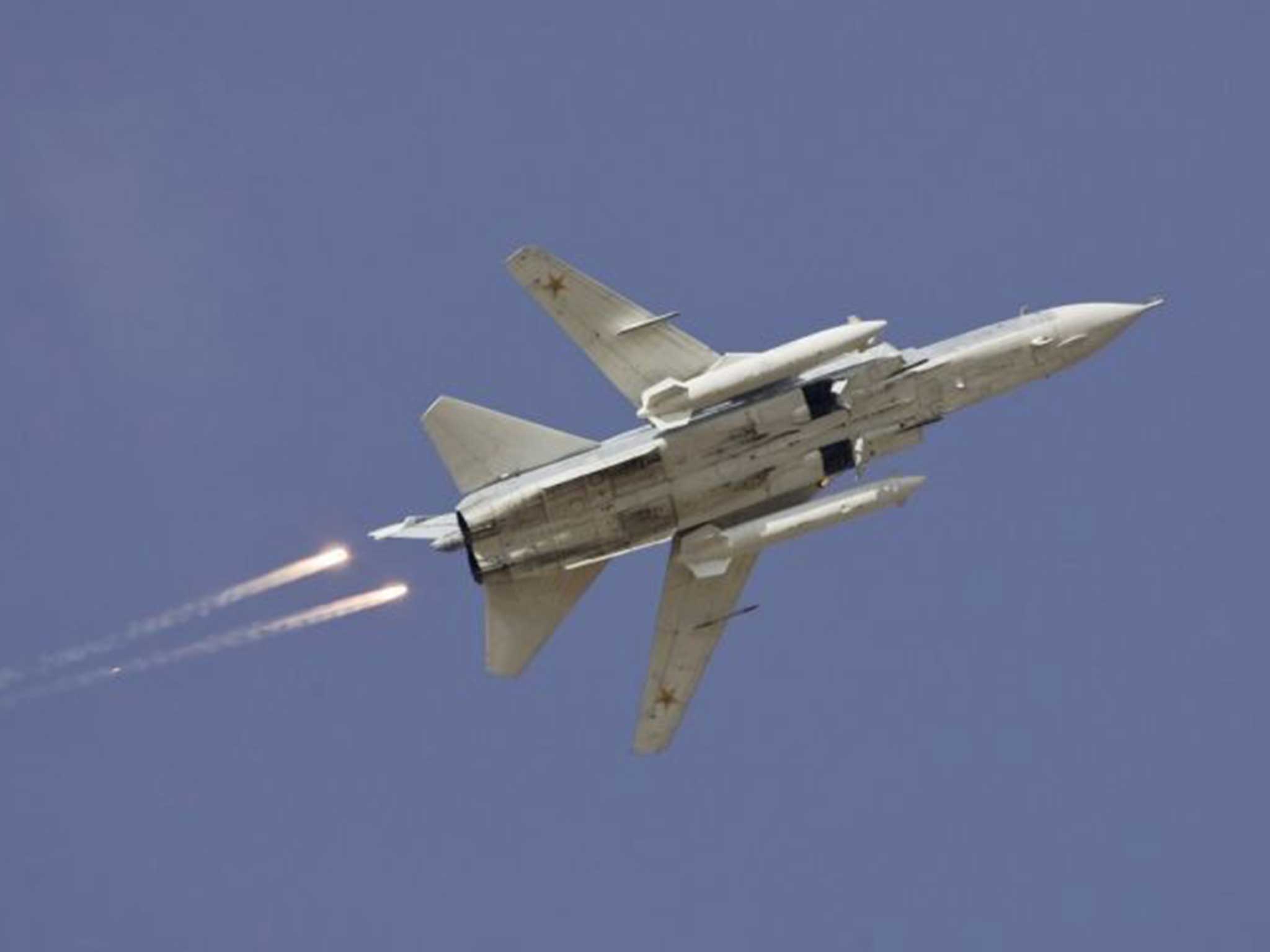 File: A Russian SU-24 drops flares during a joint Kazakh-Russian military exercise