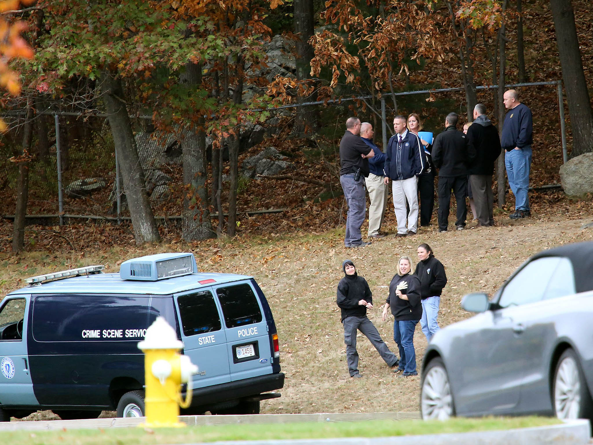 Police at the scene where the body of Colleen Ritzer was found, in the woods behind the school she worked at