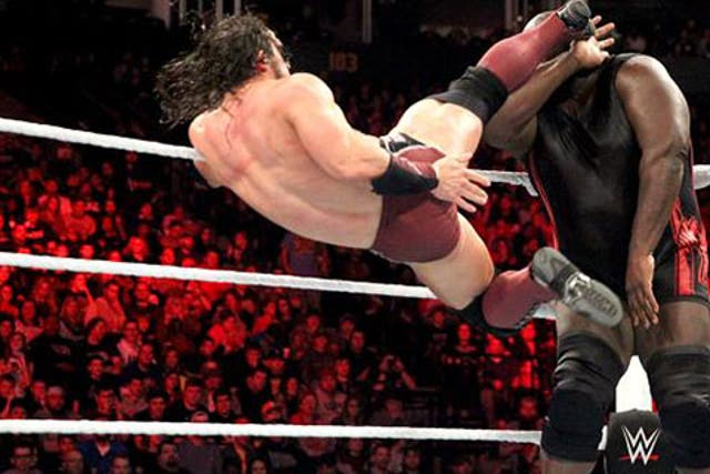 WWE star Neville lands a kick on Mark Henry