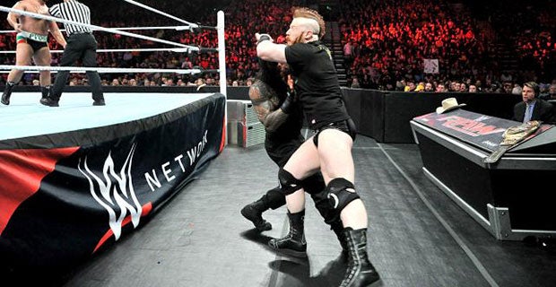 Sheamus hits Reigns with his title