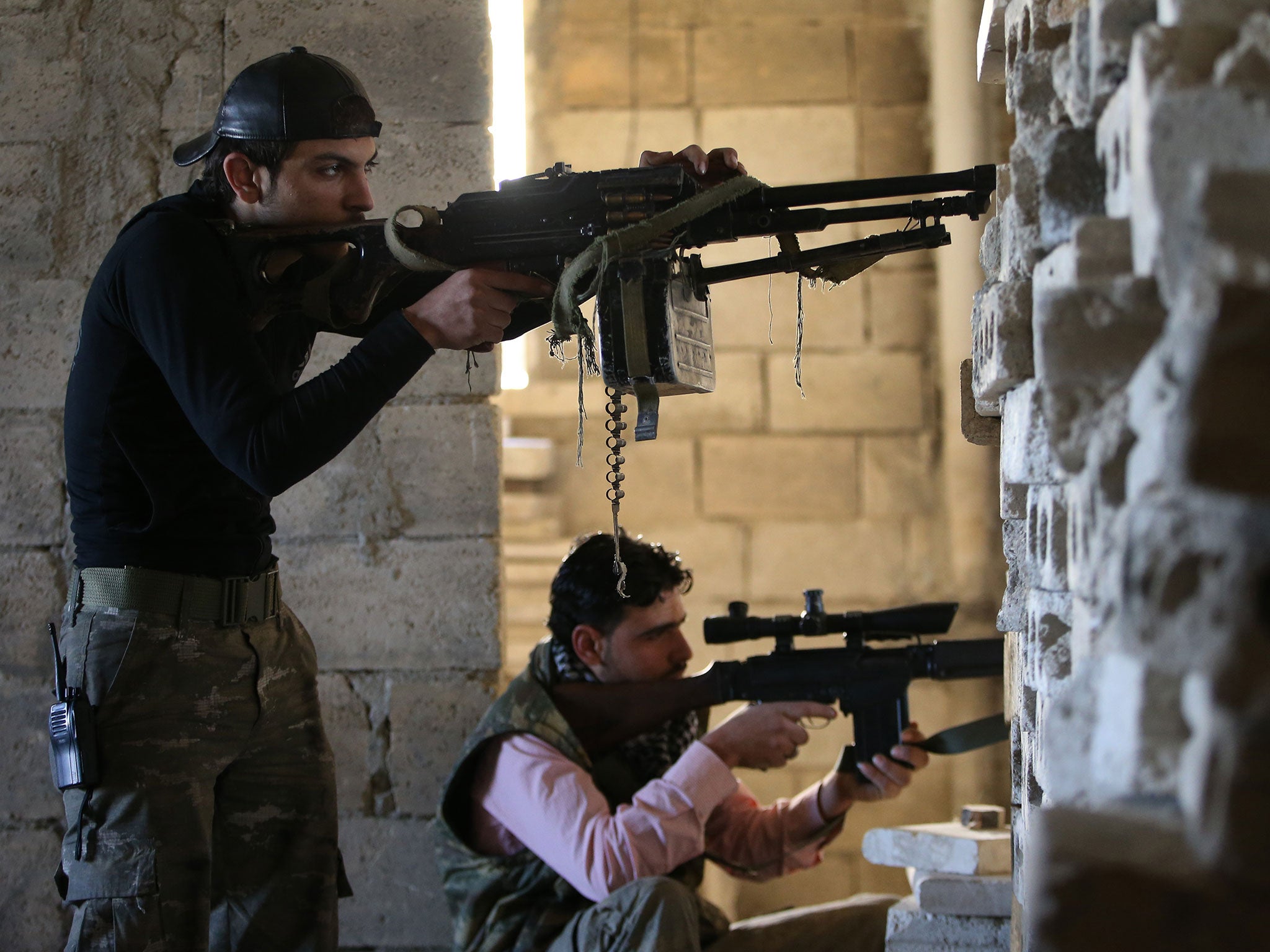 File: Free Syrian Army fighters, take positions against the Syrian regime forces base of Wadi al-Deif, at the front line of Maarat al-Nuaman town, in Idlib province, Feb. 26, 2013