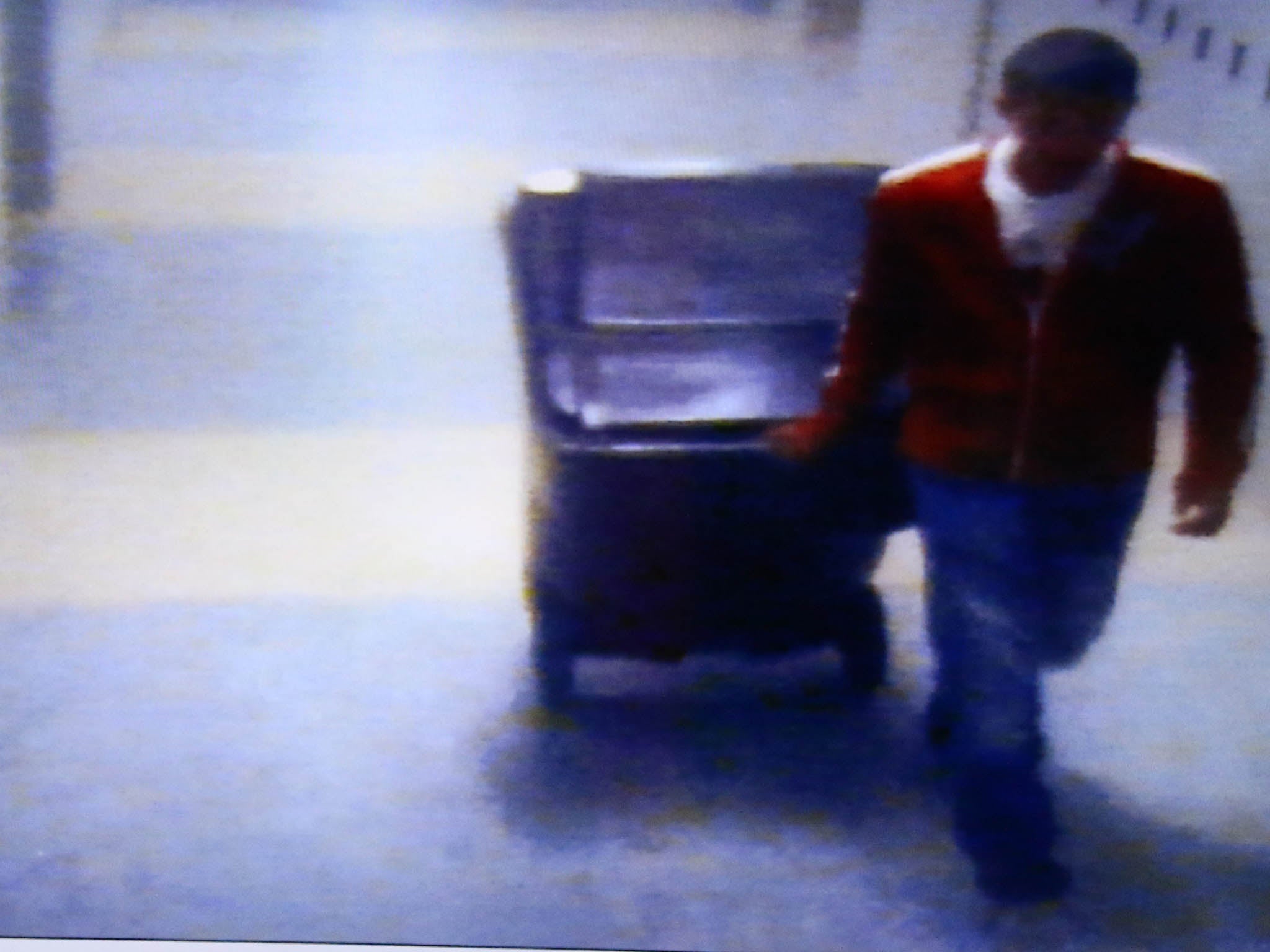 A video frame grab shown by defence attorney Denise Regan shows Philip Chism wheeling a large garbage can in a hall of Danvers High School, in the trial for the murder Colleen Ritzer