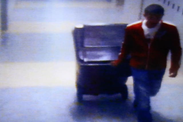 A video frame grab shown by defence attorney Denise Regan shows Philip Chism wheeling a large garbage can in a hall of Danvers High School, in the trial for the murder Colleen Ritzer
