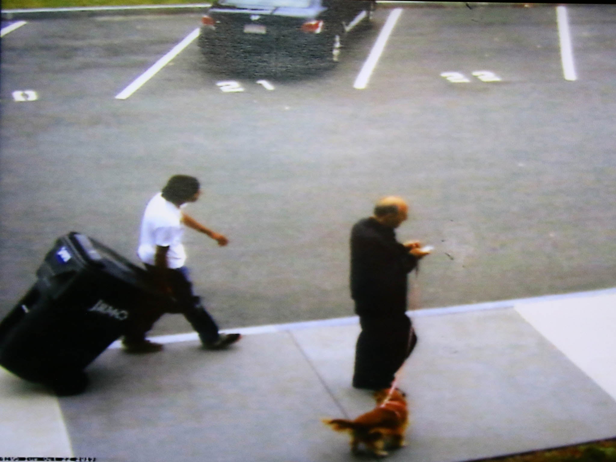 Defense attorney Denise Regan shows a video frame grab of her client, Philip Chism, wheeling a large garbage can along the Danvers High School sidewalk, during morning session of his trial