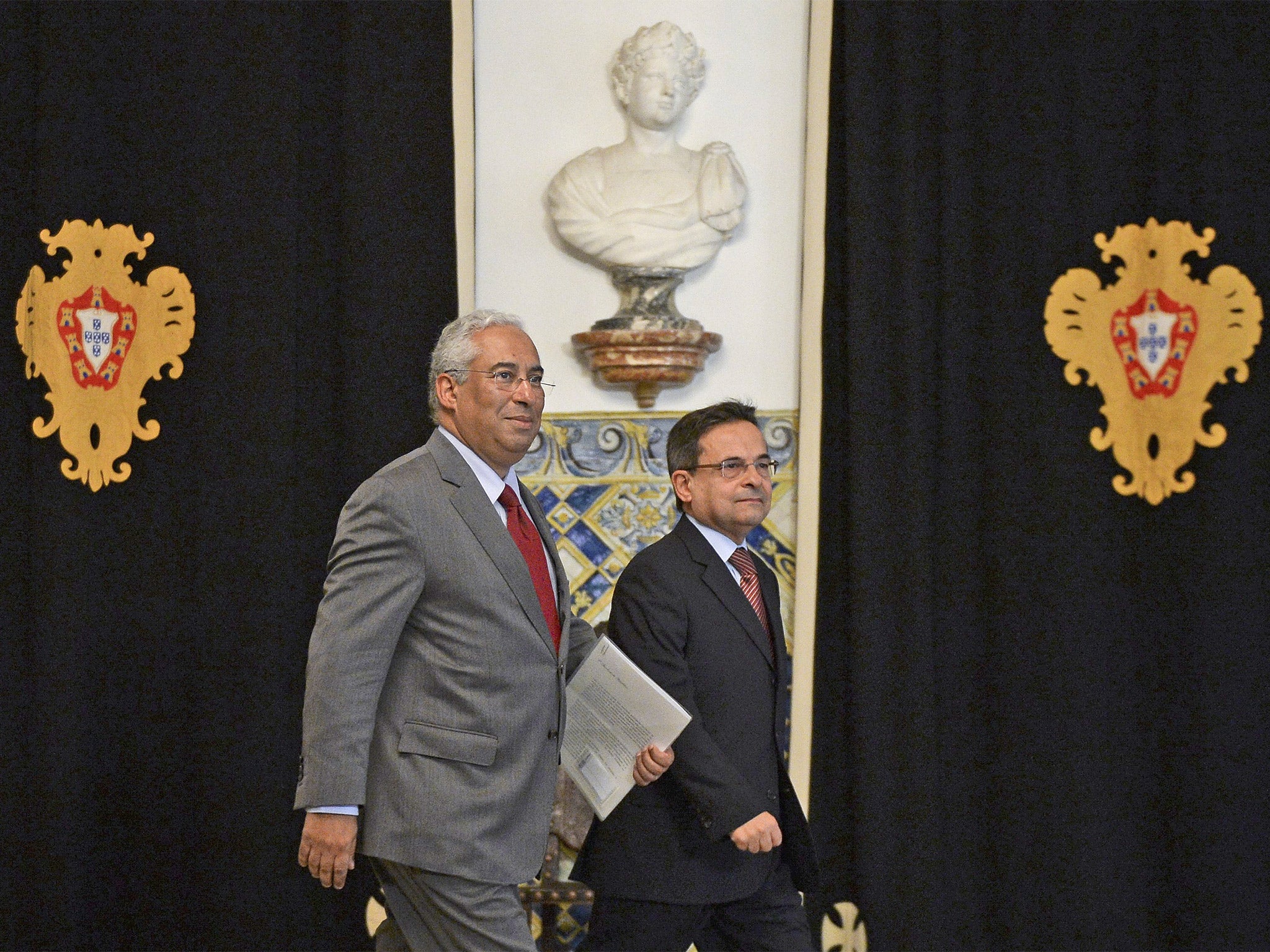 Leader of the Socialist Party Antonio Costa, left, leaves after meeting Portugal's president at Belem Palace in Lisbon