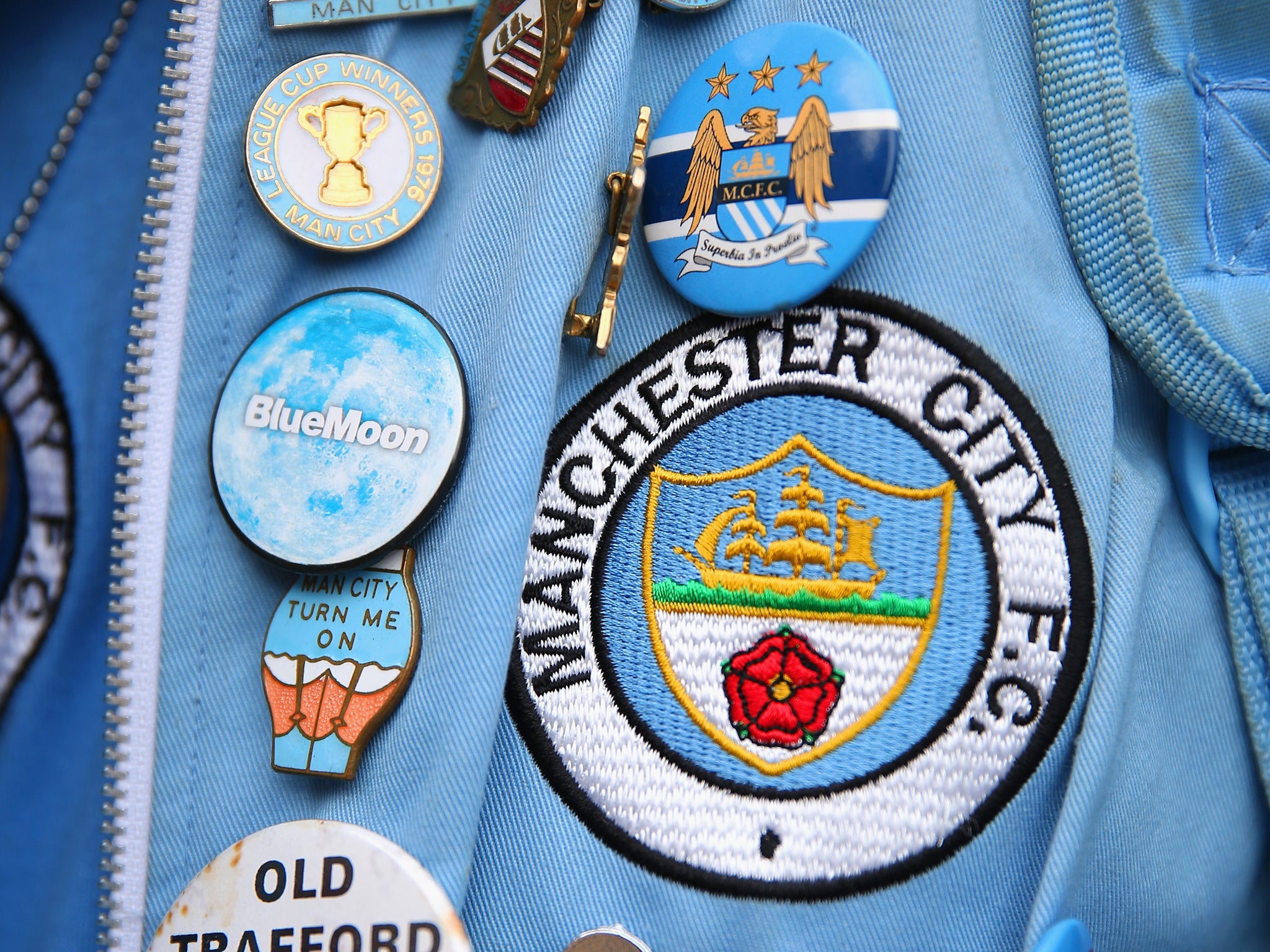 Manchester City's former badge (main), used between 1972 and 1997, with the club's current badge featuring above