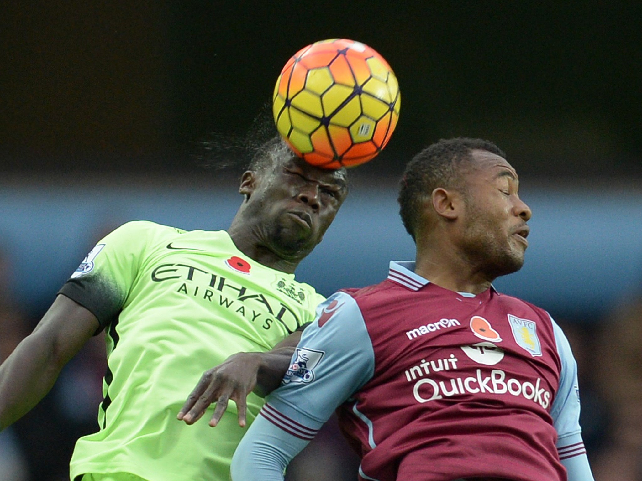Manchester City's Bacary Sagna wins an aerial duel with Aston Villa's Jordan Ayew