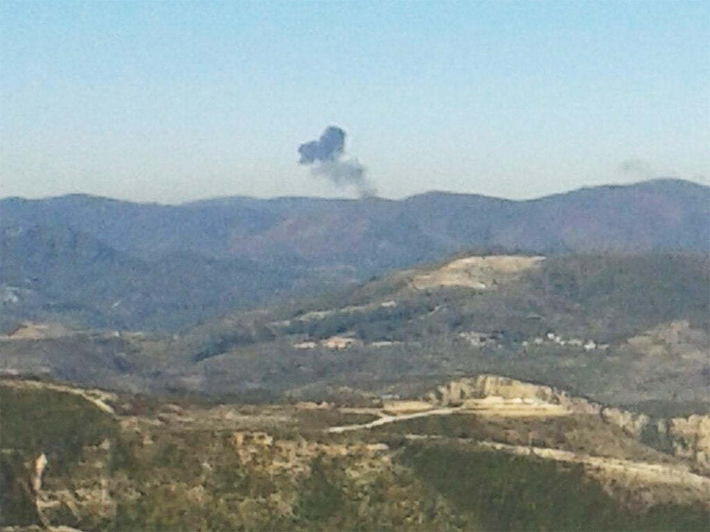 Smoke rises over mountainous area in northern Syria after a Russian plane was shot down by Turkish fighter jets near the Turkish-Syrian border