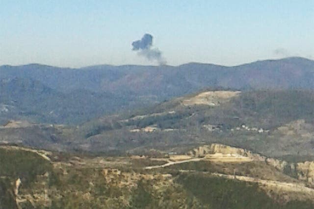 Smoke rises over mountainous area in northern Syria after a Russian plane was shot down by Turkish fighter jets near the Turkish-Syrian border