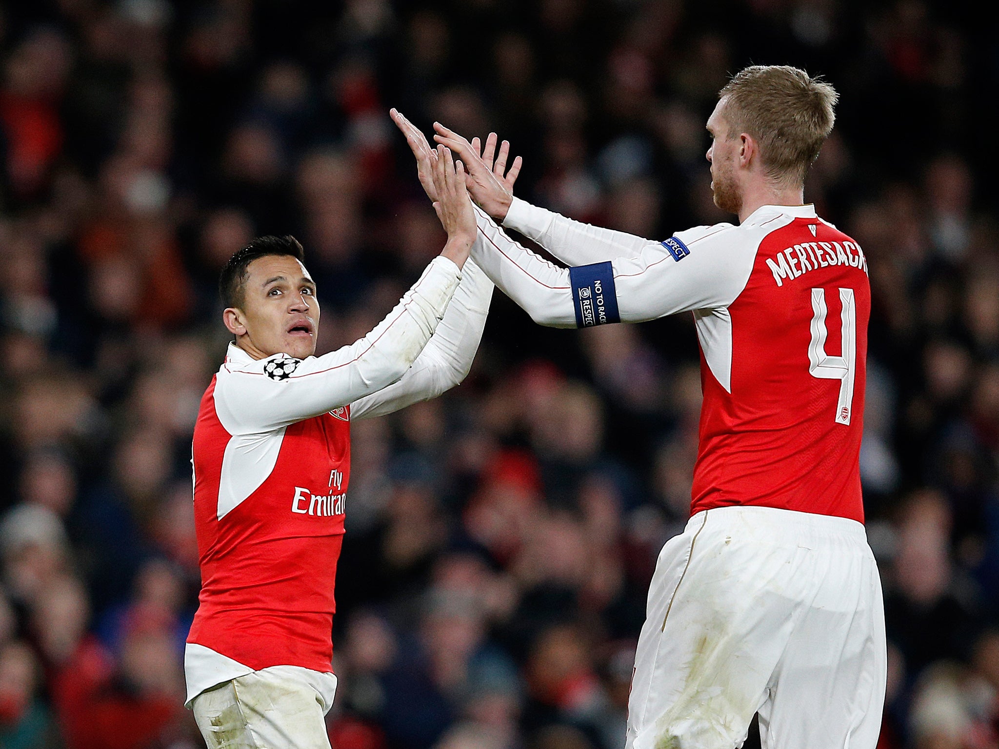 Alexis Sanchez is congratulated by Per Mertesacker on his second goal