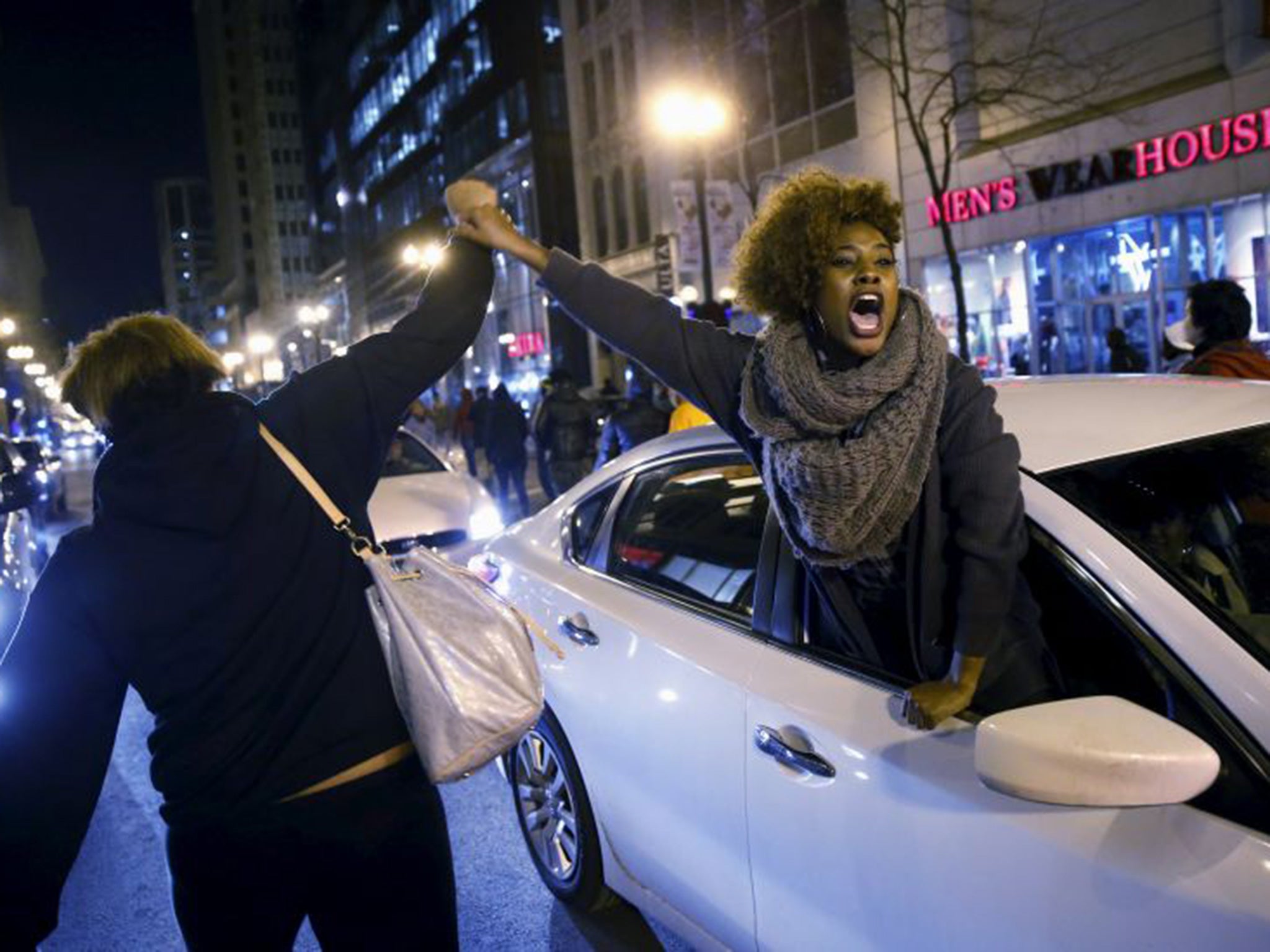 A woman greets protesters out of a car window during the demonstrations