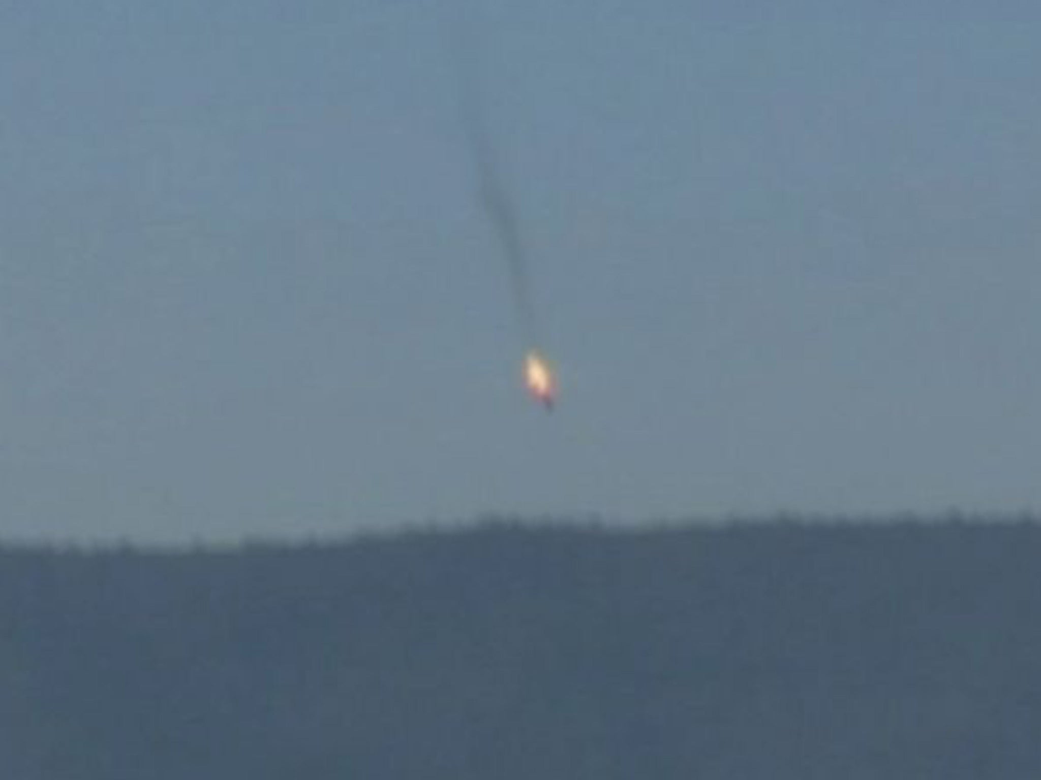 The Russian plane crashing in flames after it was shot down by Turkish fighter jets