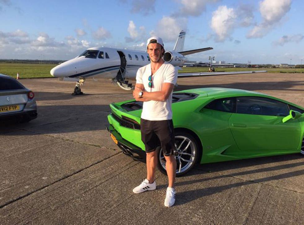 Real Madrid forward Gareth Bale poses in front of a brand new Lamborghini Aventador Roadster