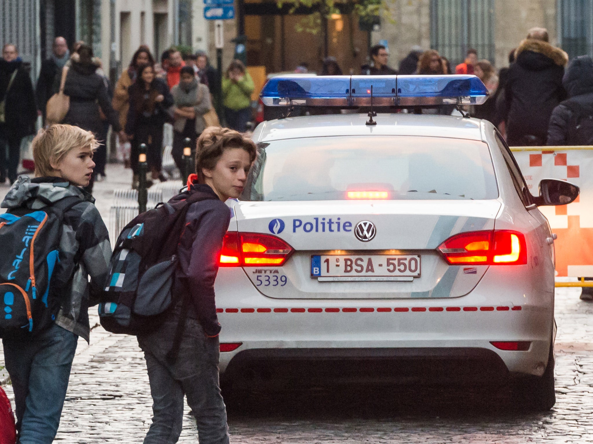 A police car patrols near a school in Brussels