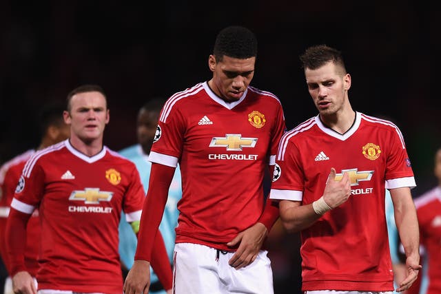Manchester United's players trudge off following their stalemate against PSV