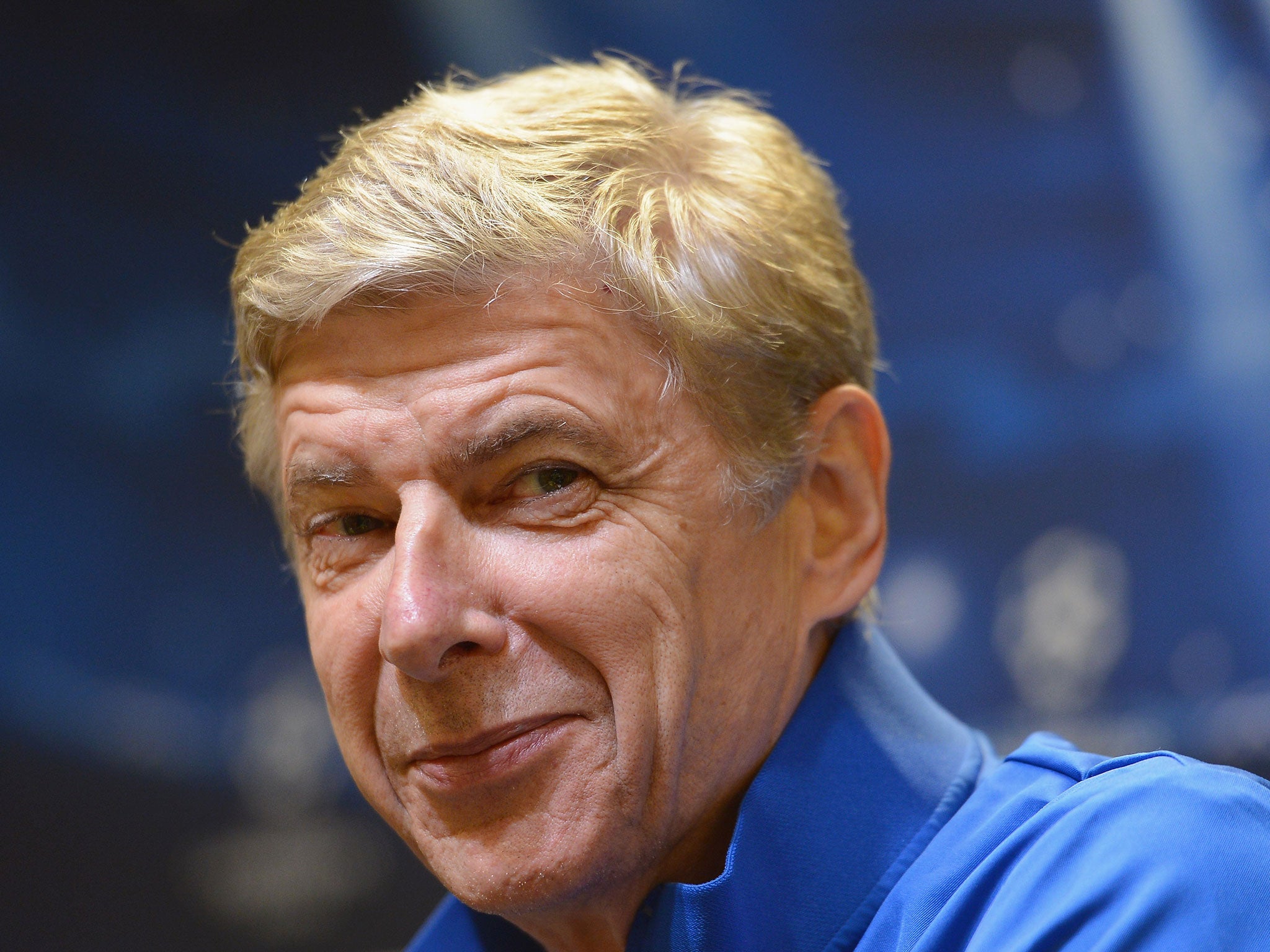 Arsenal manager Arsene Wenger hints at a smile during his press conference