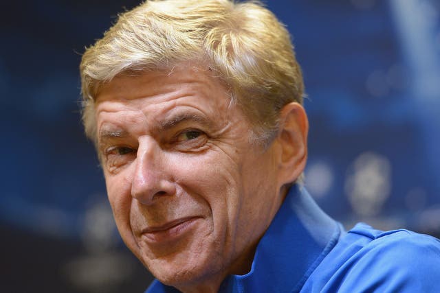 Arsenal manager Arsene Wenger hints at a smile during his press conference
