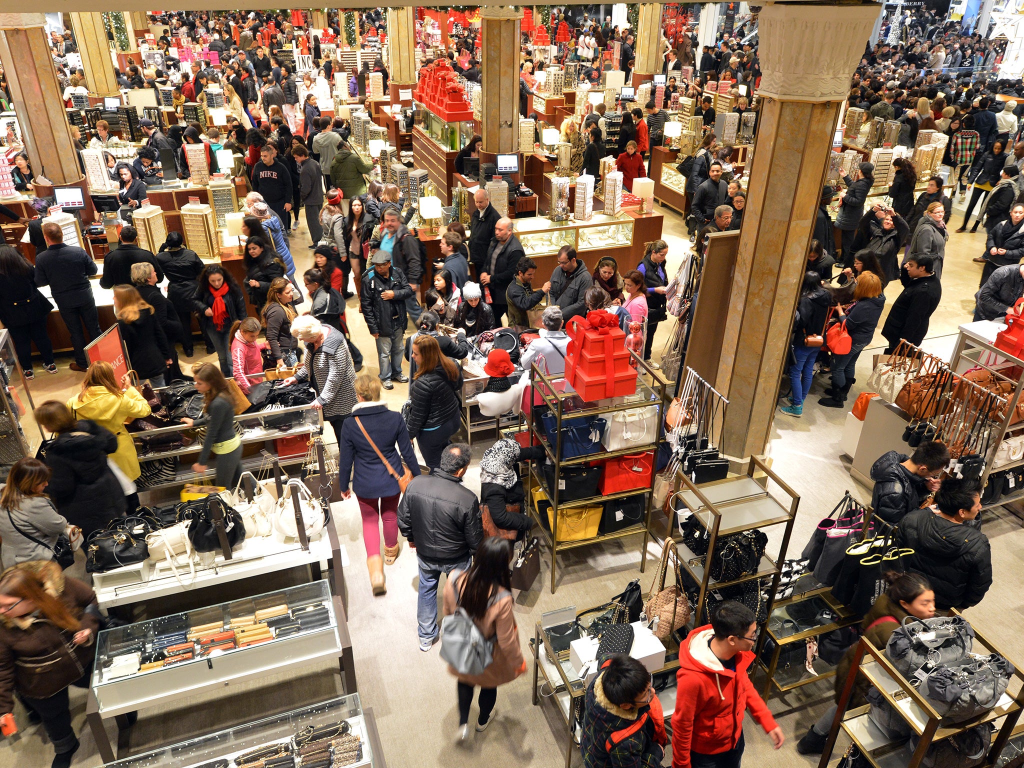 People crowd the first floor of Macy's department store as they open at midnight in 2012