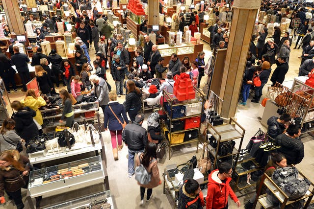 People crowd the first floor of Macy's department store as they open at midnight in 2012