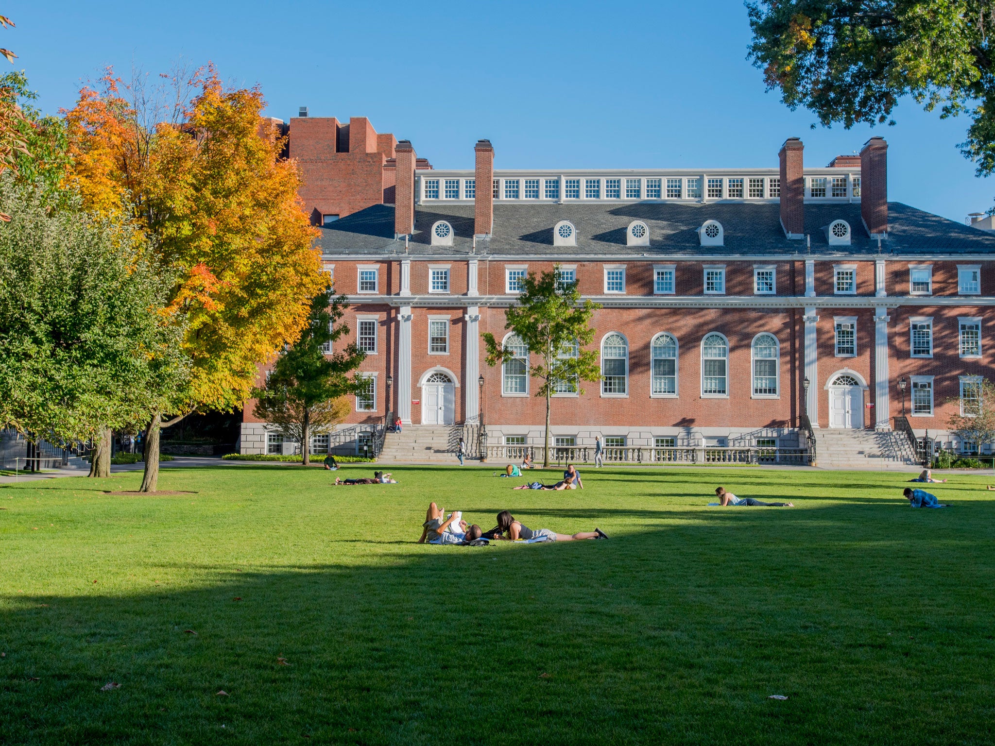 Students relax on the lawns around Harvard University in the US