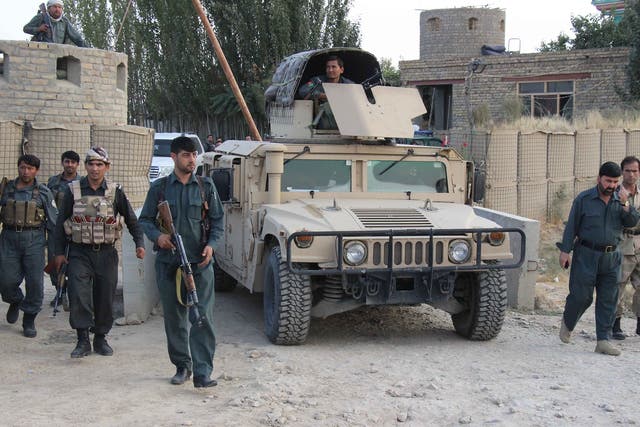 Afghan security personnel on patrol in Kunduz after Taliban insurgents briefly seized the city in September