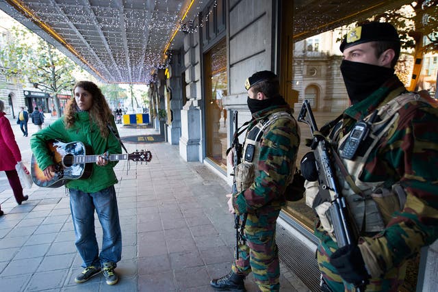 Although the threat level has fallen, soldiers will remain on guard at key points across Brussels