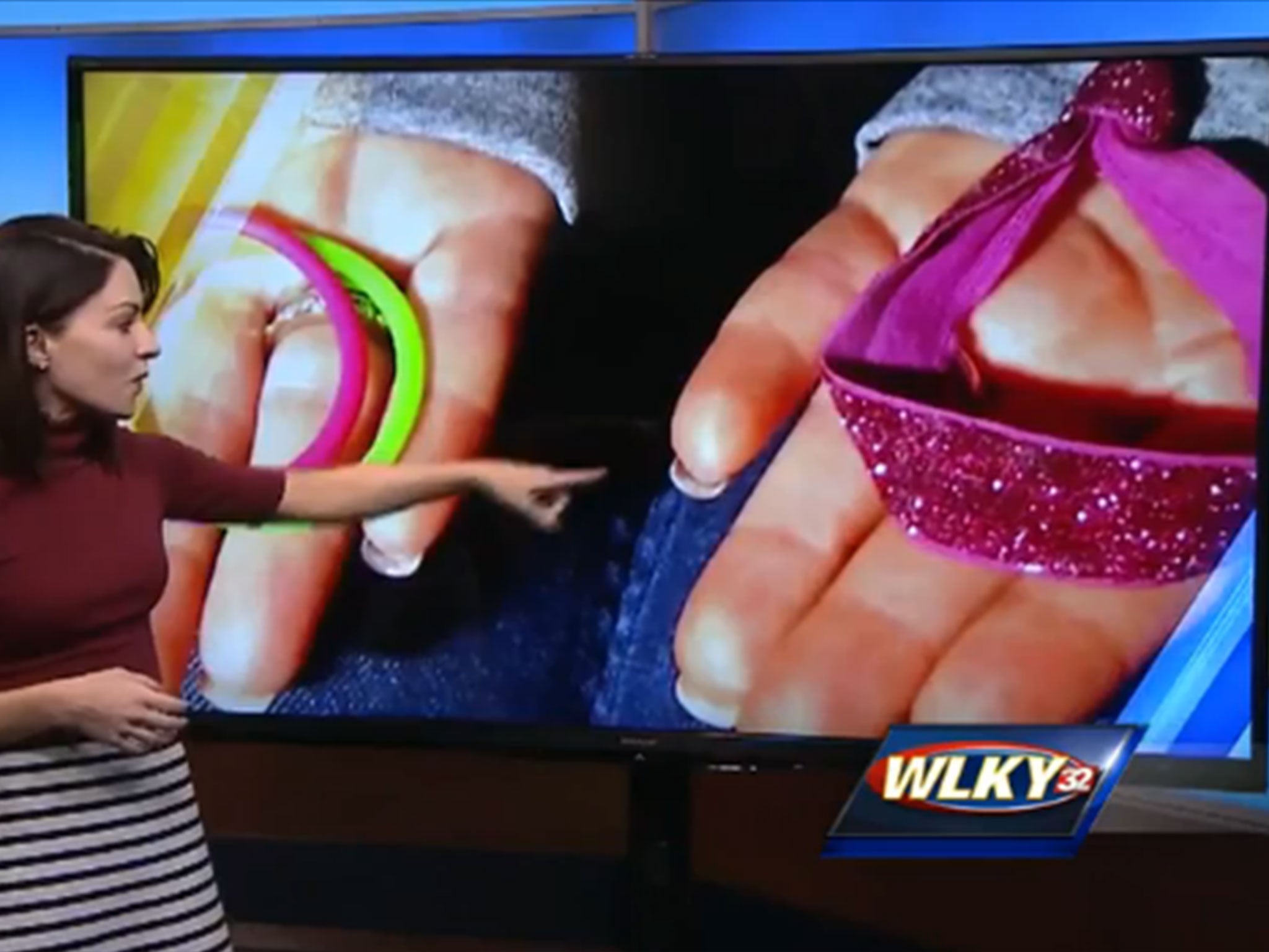 
A news reporter gestures towards the type of hair band which caused Ms Kopp's problem 