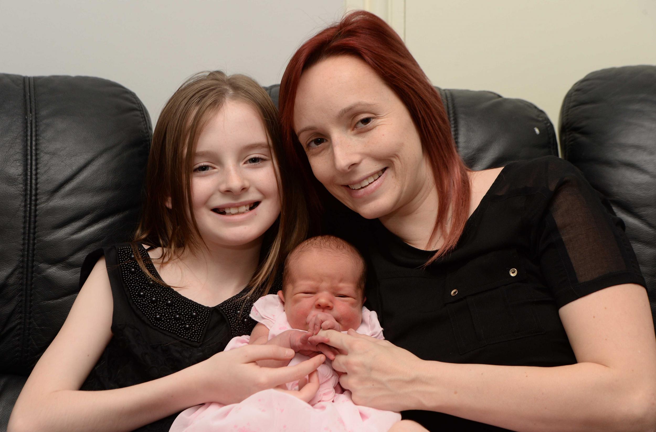Caitlin Burke with her mother and baby sister