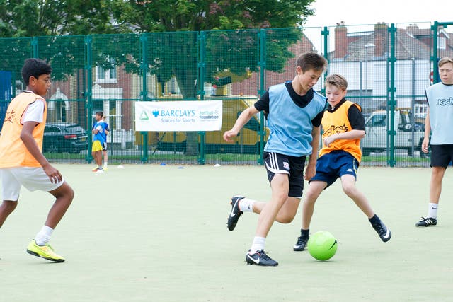 A group of youngsters play on the Bransbury Park pitch in Portsmouth funded by Barclays and the Football Foundation