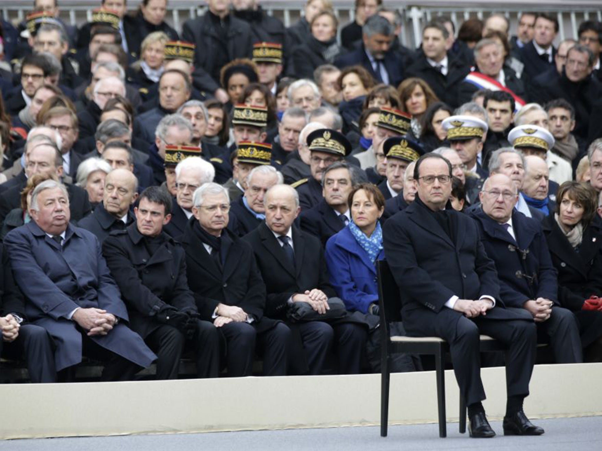 French President Francois Hollande, right, attends a ceremony to honor the 130 victims killed in the 13 November attacks