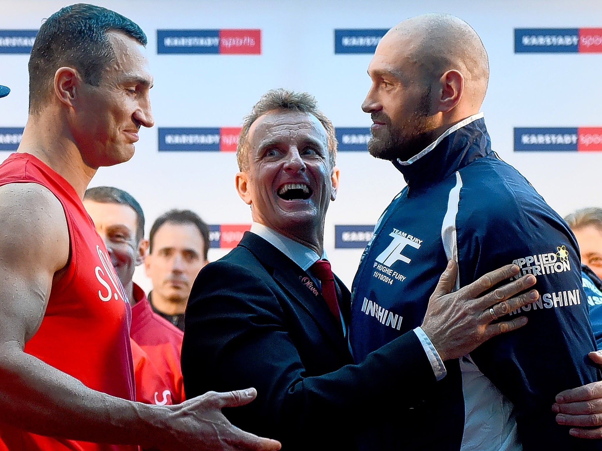 Wladimir Klitschko (left) extends his hand to Tyson Fury during the weigh-in in Germany