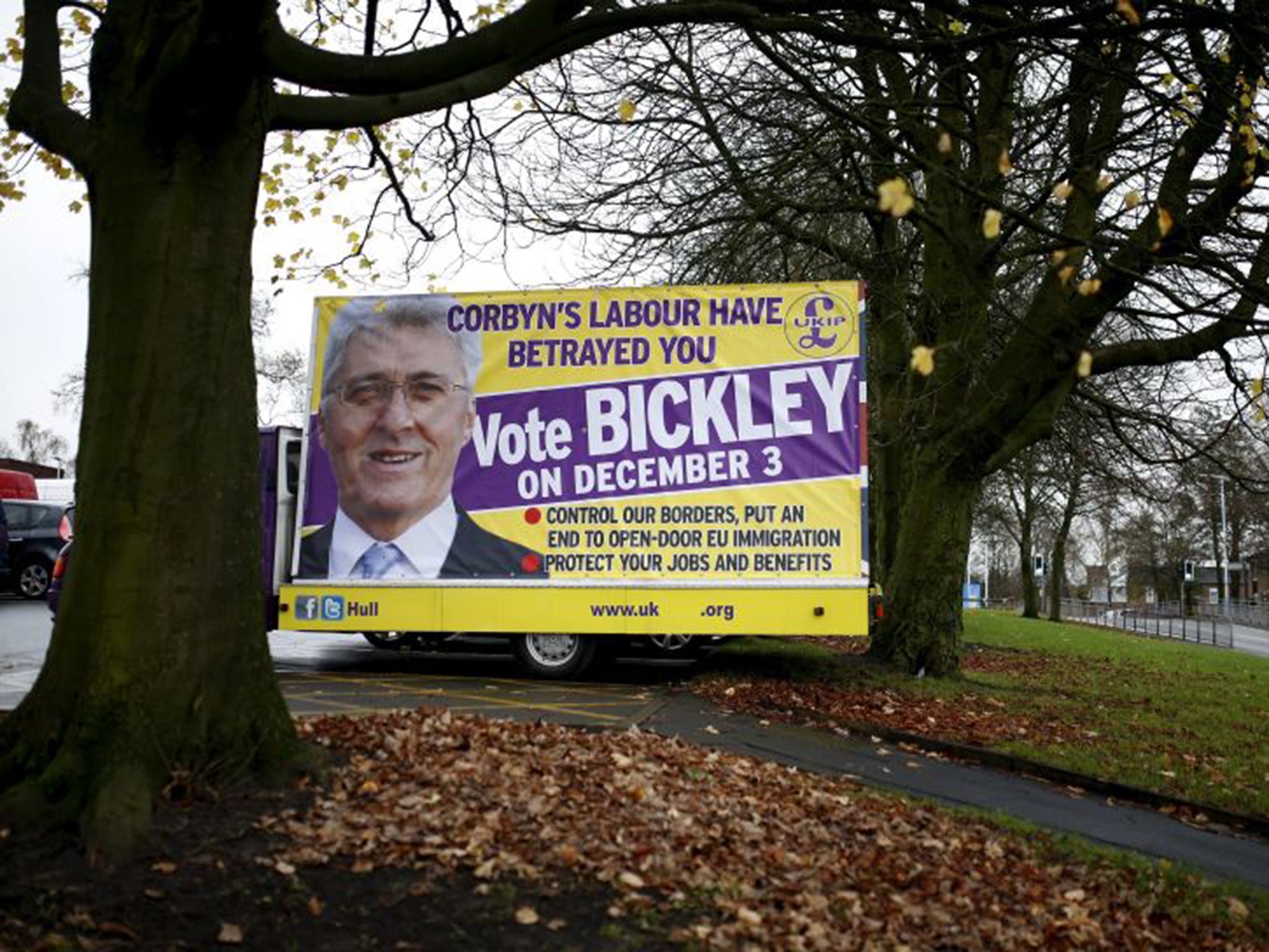 A poster featuring UKIP party candidate John Bickley stands in a car park outside Royton Market near Oldham