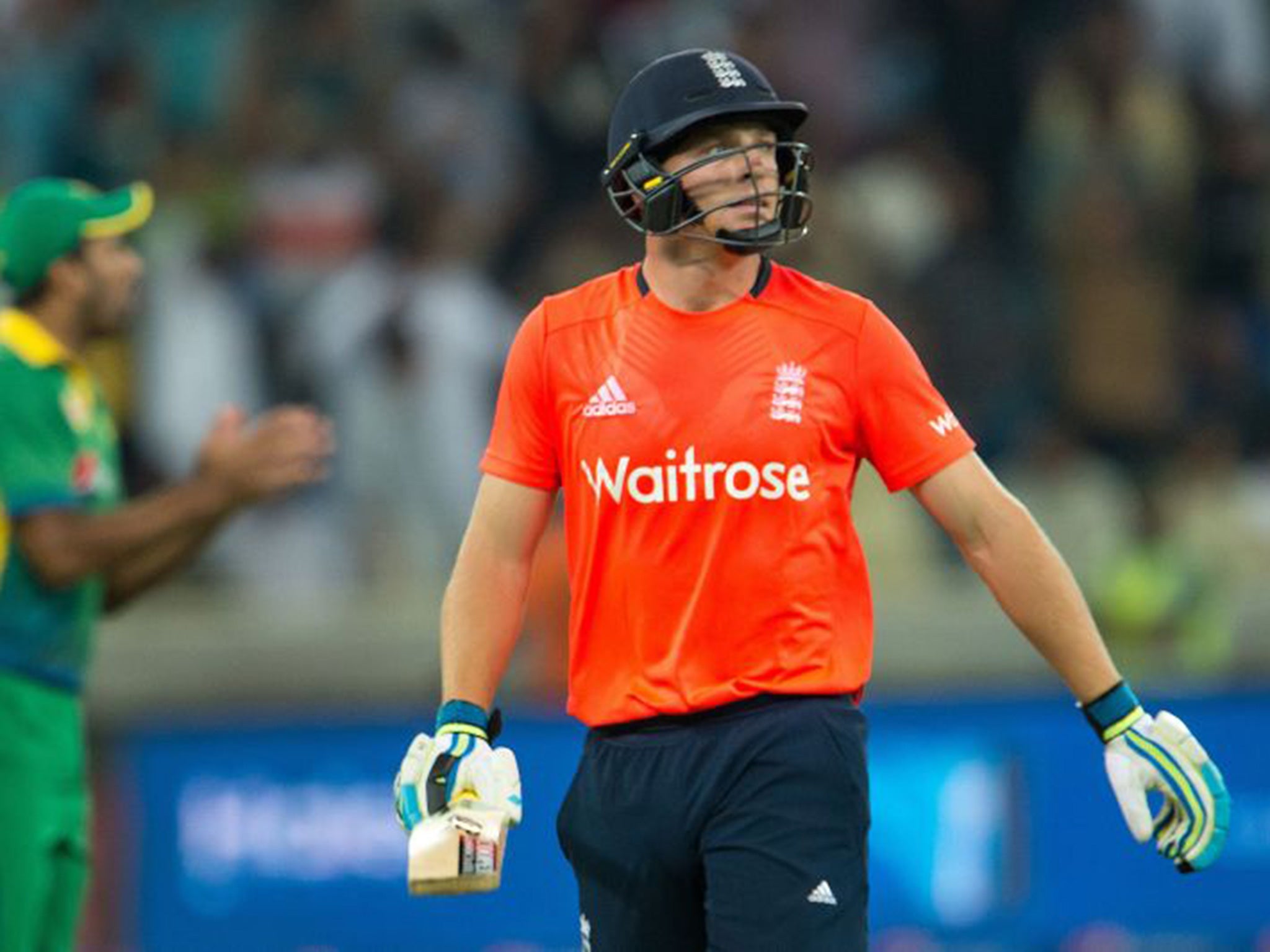 England's captain Jos Buttler leaves the pitch after being dismissed during the second T20 cricket match between Pakistan and England