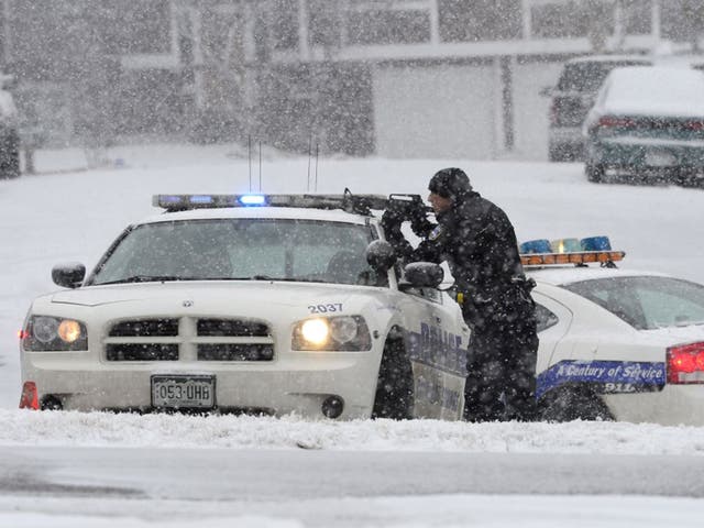 An officer waits after reports of a shooting near a Planned Parenthood clinic Friday, Nov. 27, 2015, in Colorado Springs,