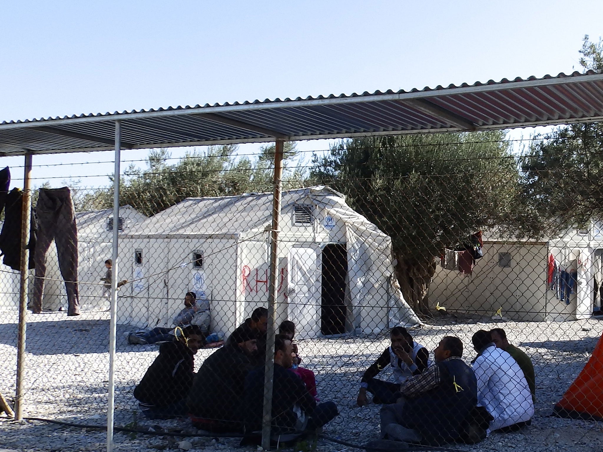 Asylum seekers sitting outside the Ikea shelters at Kara Tepe refugee camp in Lesbos, November 2015.