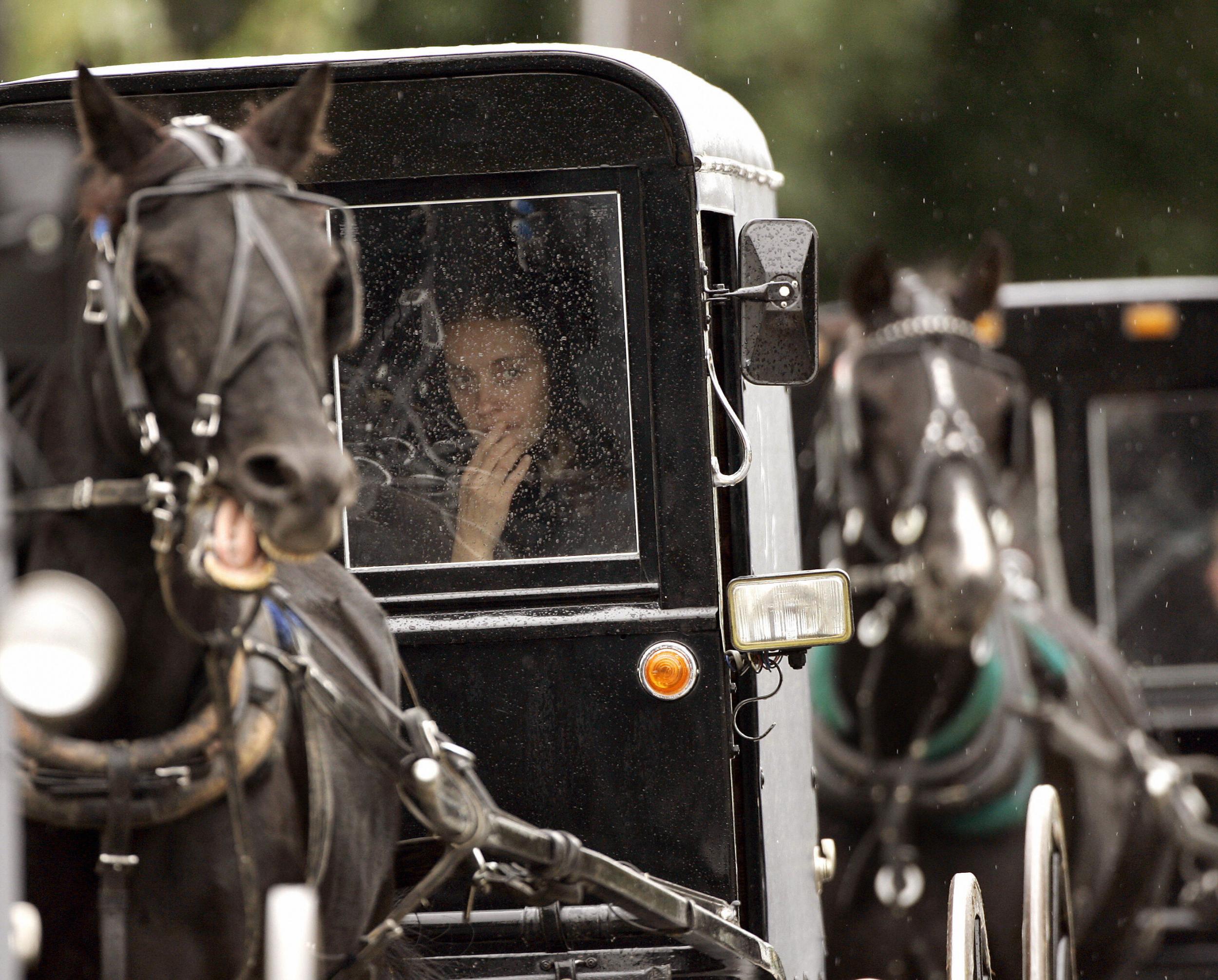 An Amish funeral procession for one of the victims of the shooting